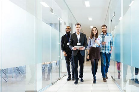Full-length-of-group-of-happy-young-business-people-walking-the-corridor-in-office-together-2.0